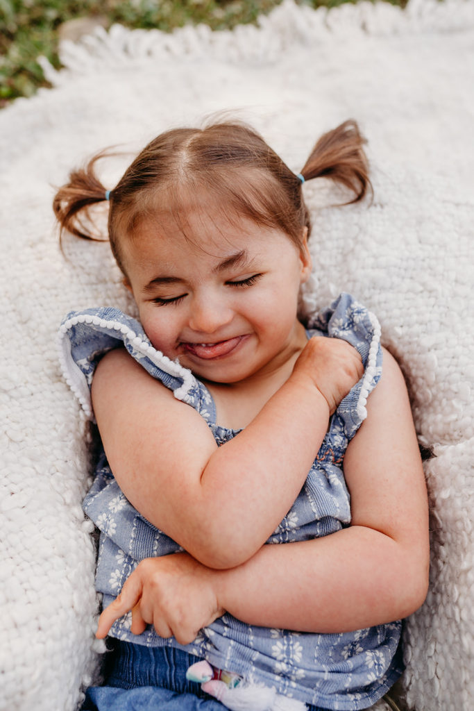 child smiling with eyes closed